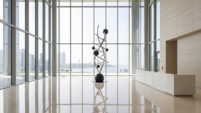 Modern Abu Dhabi corporate office tower lobby with marble floors and a minimalist sculpture
