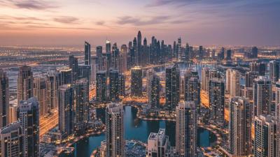 Aerial dusk view of Jumeirah Lakes Towers (JLT) with 67 high-rise towers around four artificial blue lakes