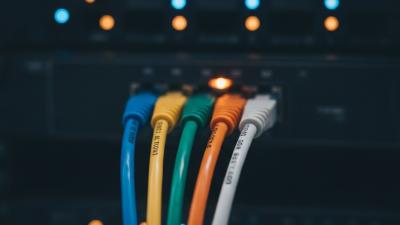 Five coloured network cables converging into one glowing switch port — the UAE e-invoicing five-corner model