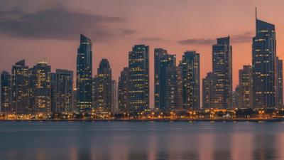 Abu Dhabi Corniche residential towers at dusk seen from the water